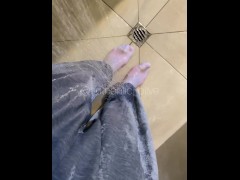 Girl soaks and splashes in socks and sweatpants in shower