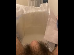 Diaper boy inserting butt plug