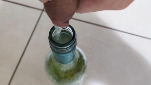 Filling up a 750mL bottle of wine with piss
