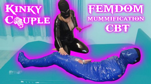 Femdom Goddess whips balls of mummified slave