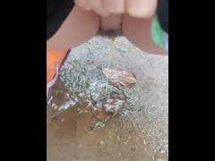 Girl Peed desperately in the rain to the puddle