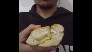 Eating a bread with egg on it