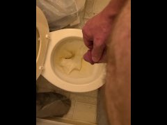 Pissing playing with dick