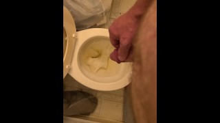 Pissing playing with dick