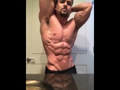 Jacked bodybuilder Benji Bastian flexing his huge