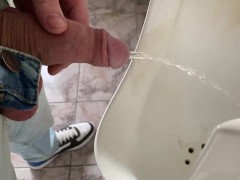 Guy peeing in public office toilet