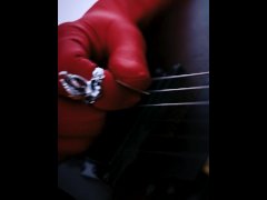 Coomer - a man in red gloves masturbates and plays the guitar