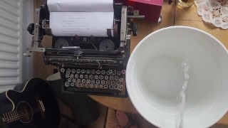Pissing in the bucket next to typewriter spilling on the table