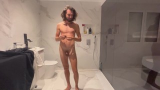 Man's cold shower routine in the bathroom and his reaction