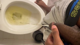 Young black dude pulls down underwear and pisses