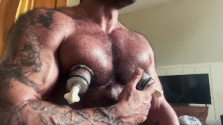 Muscle Daddy uses his nipple suckers and dick pump.