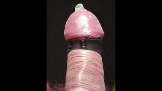 Vibrating penis in condom in slow motion