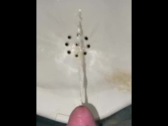 Guy pees in a urinal very close POV