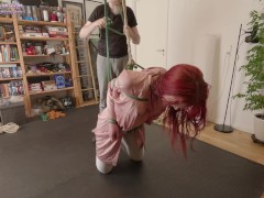 Elbows tied together, balancing on her knees with neck rope