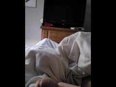 Laying in bed playing with his cock