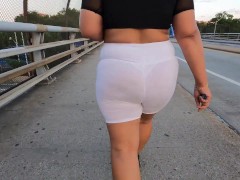 White see through shorts with white thong walking