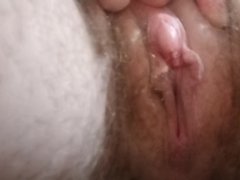Close-up of pussy and large clit while pissing