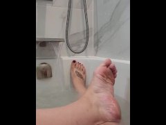 Beautiful wet feet in the bath