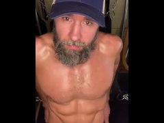 Bearded jock strokes his long cock
