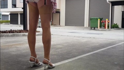 Crossdresser walking outdoors in mini skirt