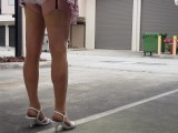 Crossdresser walking outdoors in mini skirt