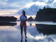 Alena Witch walks around a beach dressed in wet t shirt