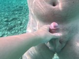 Stranger girl saw naked guy in the sea and start masturbate his dick until he cum underwater