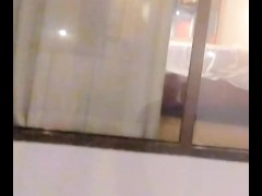 She catches voyeur watching through hotel window-decides to take of panties give him a show