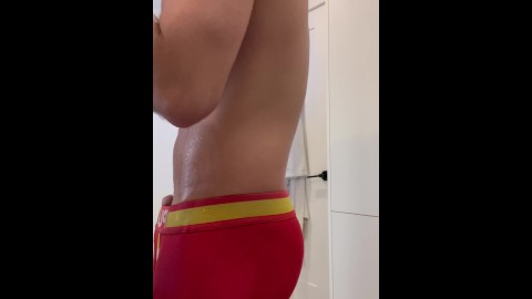 Handsome fit man vaping and pissing in underwear