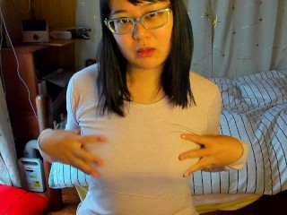 A Busty Japanese Woman Feels Good by Caressing her Nipples through her Innerwear.