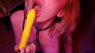 girl shows off her body and sucks on a toy