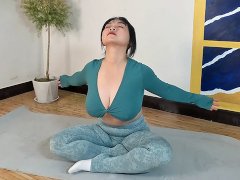 Beautiful busty girl doing soothing yoga fitness exercises