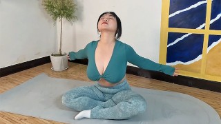 Beautiful busty girl doing soothing yoga fitness exercises