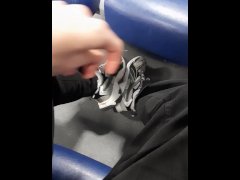 A young guy shows his legs in fashionable sneakers on the train