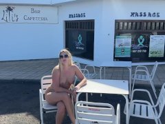 girl sitting naked in a cafe in public