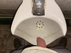 Hands-free pissing in a public toilet from an uncut dick