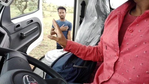 The college boy sitting in the car towards the forest goes down to the pit to use the bathroom