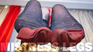 Voet plagen in zwarte nylons met witte polka dots en rode versterkte tenen