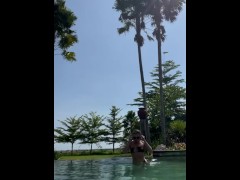 Hot fit blonde stood poolside