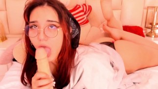 Anime girl in glasses looks adorable while sucking a rubber cock for you