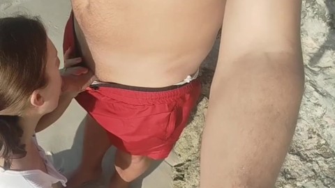 I suck on a public beach and a stranger cums on my tits.