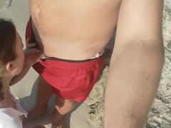 I suck on a public beach and a stranger cums on my tits.