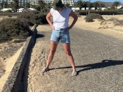 Preview 3 of girl pisses in jeans shorts at the street in public