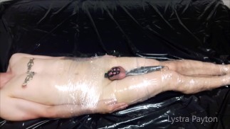 The mistress wraps the slave in plastic wrap and tortures him with vibrations on his full testicles
