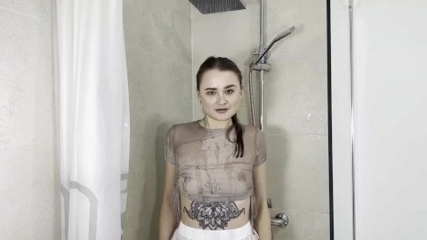 Hot crazy woman watering herself in the shower with her clothes on