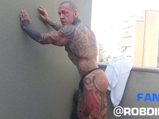 The Legend of Muscles and Ink: Tattooed Giant Rob Diesel, Shows his Power on the Balcony