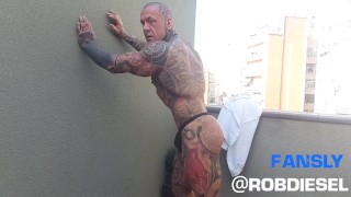 De legende van spieren en inkt: Getatoeëerde gigantische Rob Diesel, toont zijn kracht op het balkon