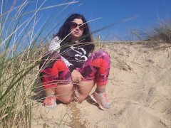 Girl pissing on the beach