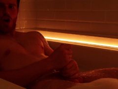 slutty guy strokes his hard cock in the bath