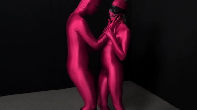 Two hot Zentai girls in different spandex colors playing with bondage ropes